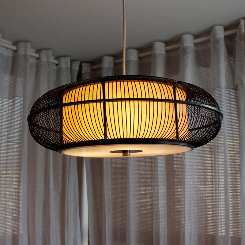 Caged circular pendant light in black or beige